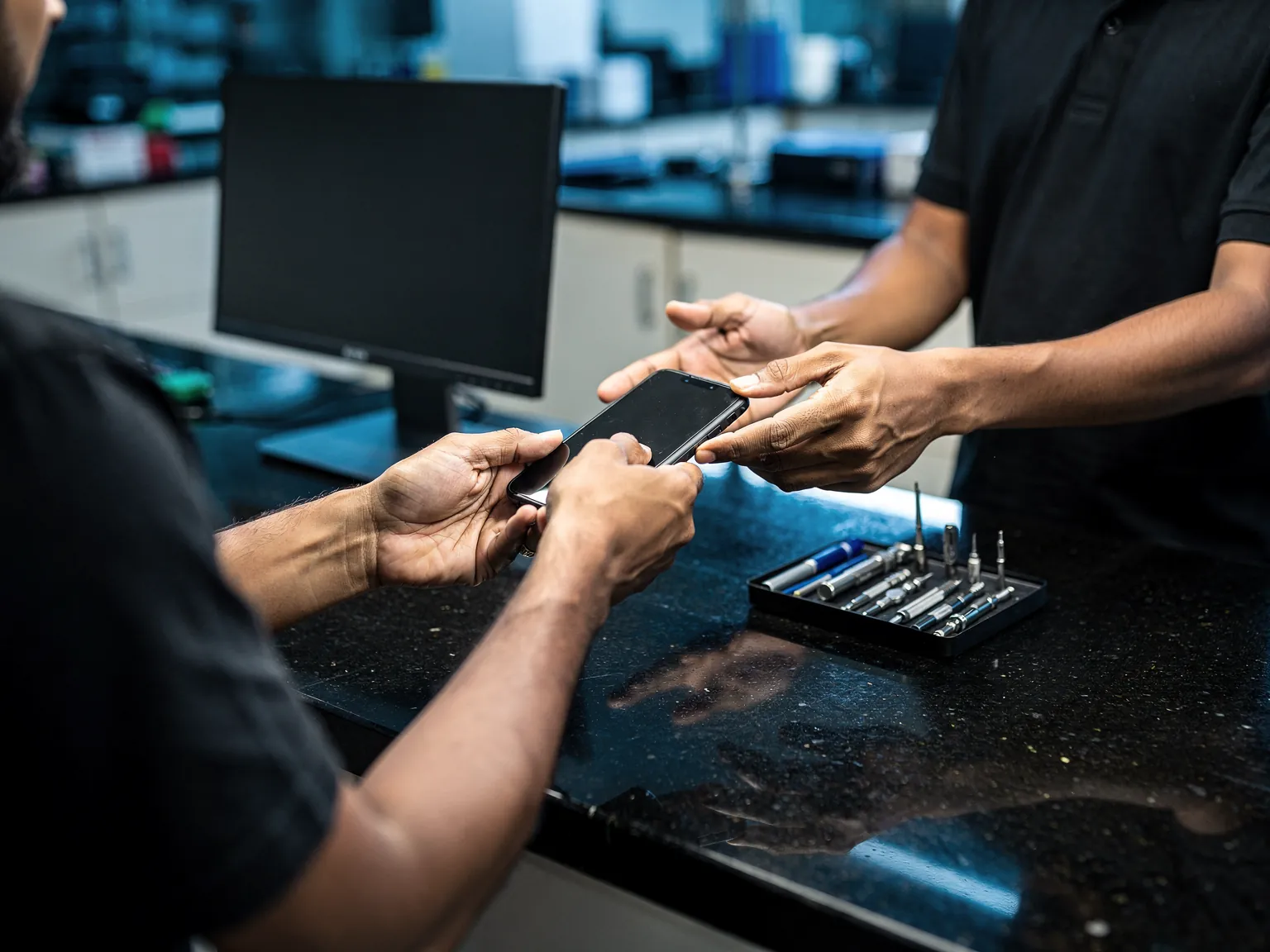 Illustration: a phone handed across a walk-in counter